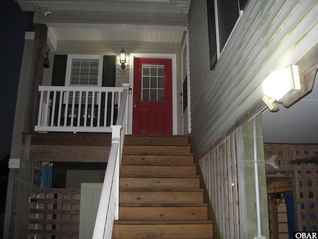 view of exterior entry featuring covered porch