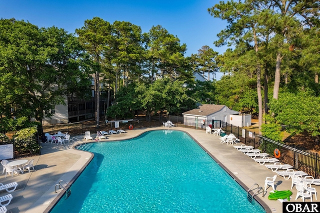community pool featuring a patio area and fence