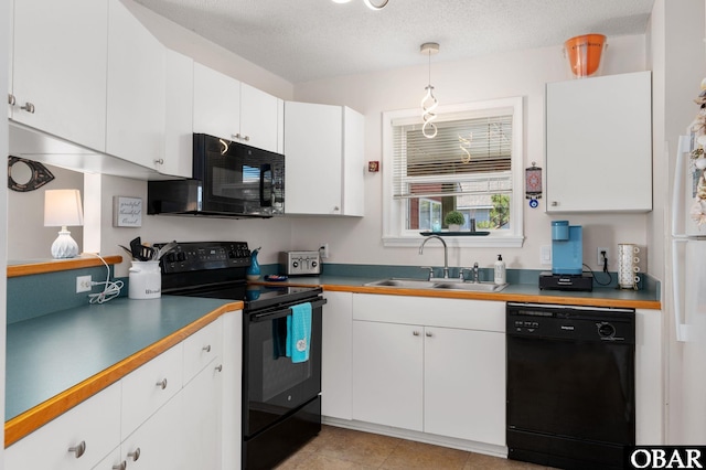 kitchen featuring white cabinets, pendant lighting, a sink, and black appliances