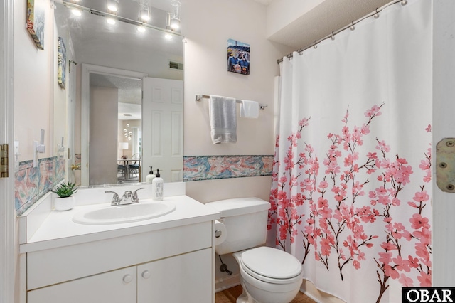 bathroom with toilet, visible vents, curtained shower, and vanity