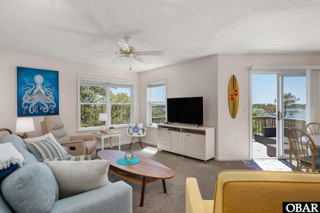 living room featuring baseboards, carpet flooring, and a wealth of natural light