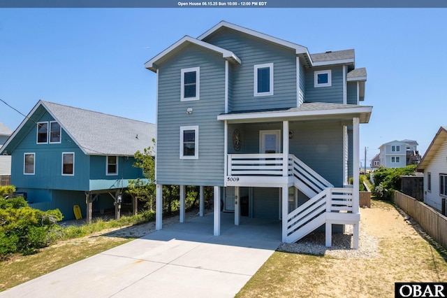 5009 Lindbergh Ave Lot 28, Kitty Hawk, NC 27949 - beach home with a carport, roof with shingles, driveway, stairway, and covered porch
