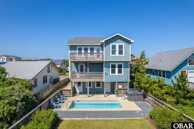 5009 Lindbergh Ave Lot 28, Kitty Hawk, NC 27949 - rear view of property with a hot tub, a balcony, a patio area, and a fenced backyard