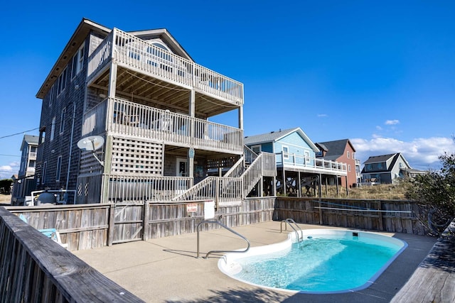 view of pool with stairway, a patio area, fence, and a fenced in pool