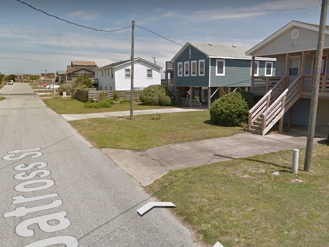 view of yard featuring stairs and a residential view