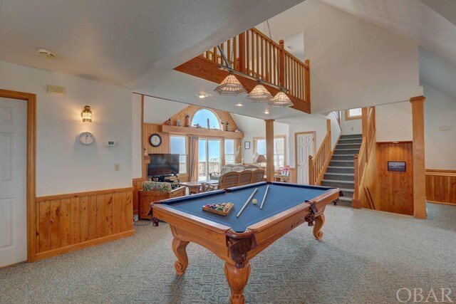 recreation room with wood walls, wainscoting, and carpet flooring