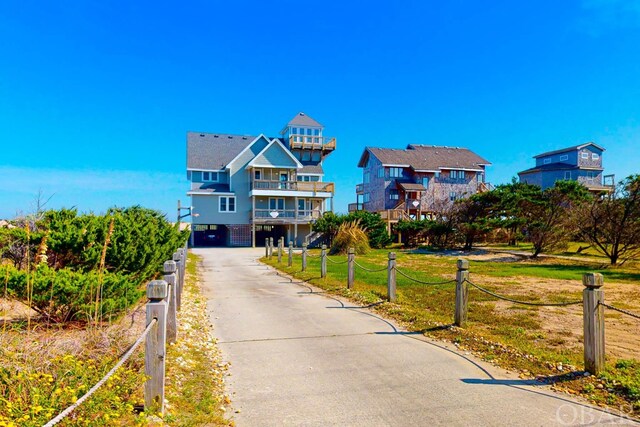 view of front of property with a carport, concrete driveway, and a residential view