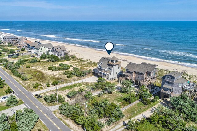 drone / aerial view with a water view, a residential view, and a view of the beach