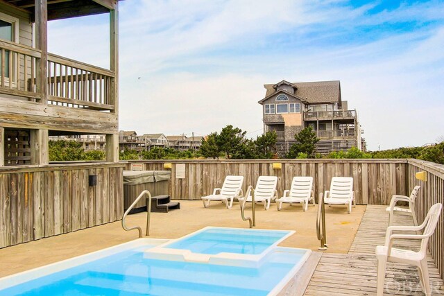 exterior space with a deck and a jacuzzi
