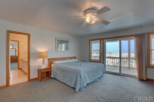 carpeted bedroom with access to exterior, ensuite bath, baseboards, and a ceiling fan