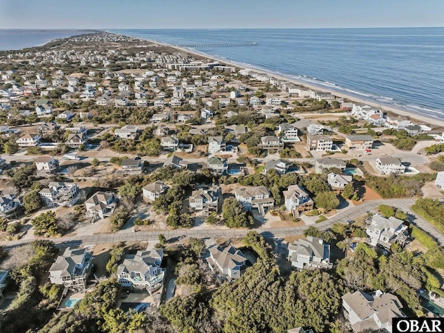 bird's eye view featuring a beach view, a water view, and a residential view