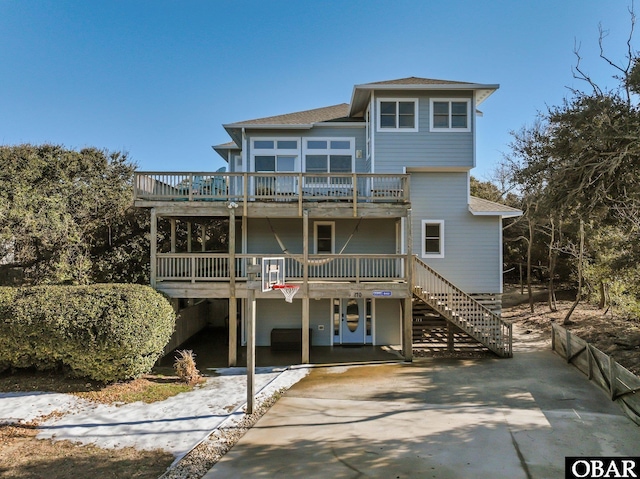 view of front of home with stairway and a deck