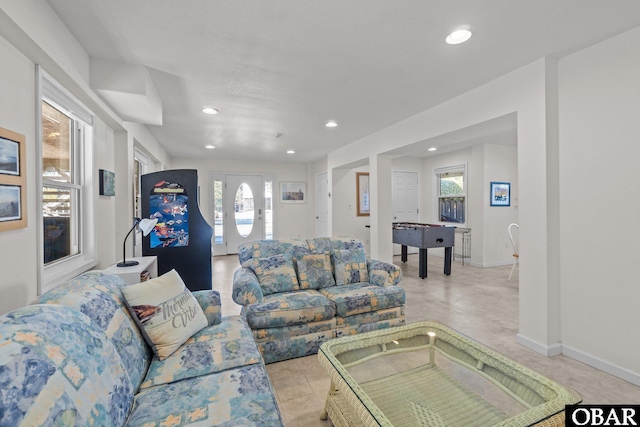 living area featuring baseboards and recessed lighting