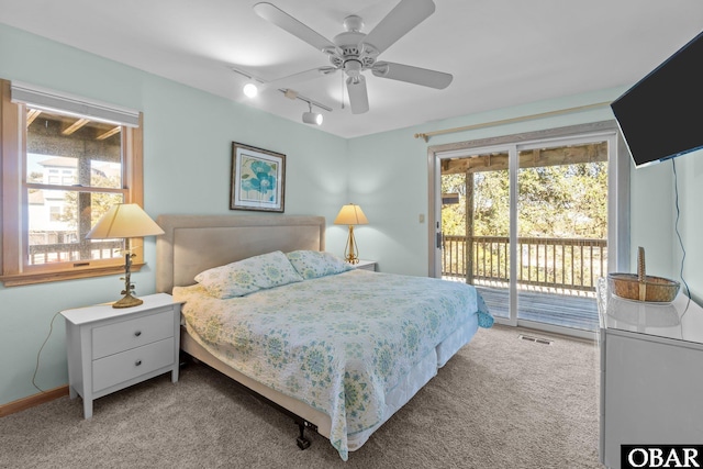 bedroom with access to outside, carpet flooring, visible vents, and track lighting