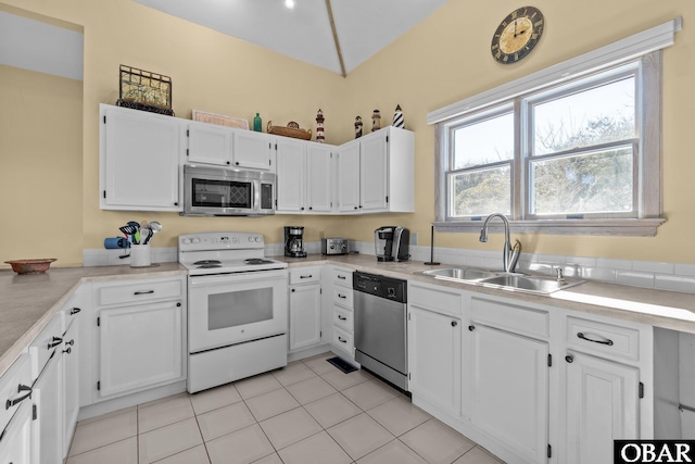 kitchen with appliances with stainless steel finishes, a sink, and white cabinets