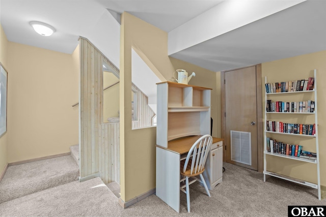 carpeted office with visible vents and baseboards