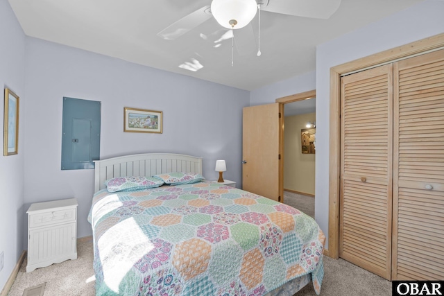 carpeted bedroom featuring a ceiling fan, electric panel, visible vents, and a closet