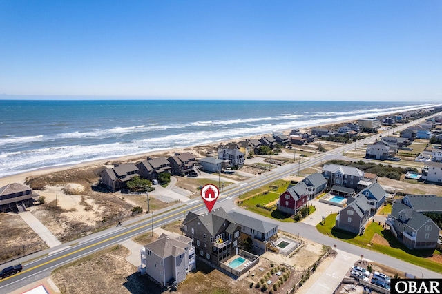 drone / aerial view with a beach view and a water view