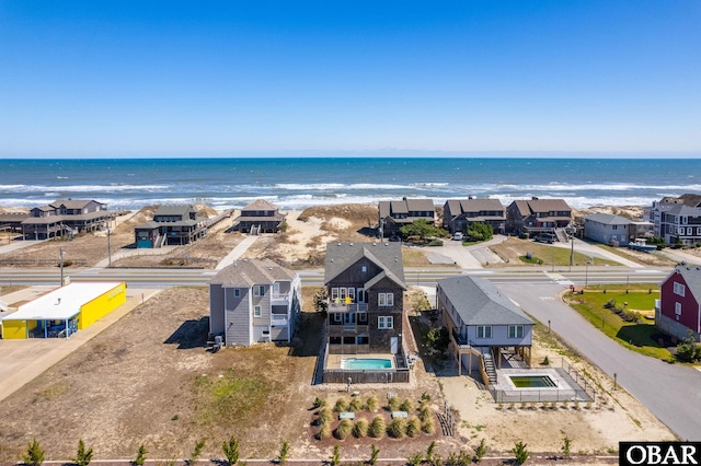 drone / aerial view featuring a residential view and a water view