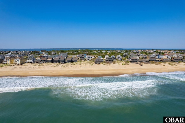 birds eye view of property featuring a beach view, a residential view, and a water view