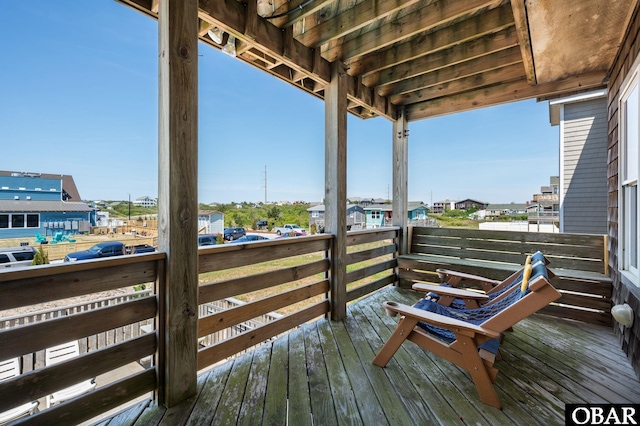 wooden terrace with a residential view