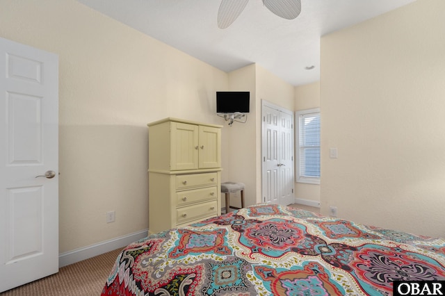 bedroom with a closet, light carpet, a ceiling fan, and baseboards