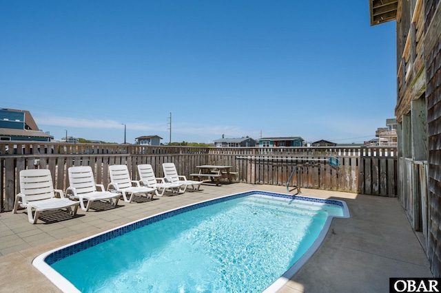 view of swimming pool featuring a fenced in pool and a patio area