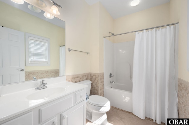 bathroom featuring shower / bath combo, tile patterned floors, wainscoting, vanity, and toilet