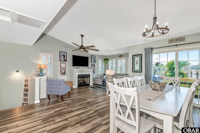 100 Amherst Dr Unit 3, Kill Devil Hills, NC 27948 - dining space with a fireplace, a chandelier, wood finished floors, vaulted ceiling, and a ceiling fan
