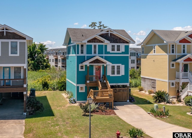 100 Amherst Dr Unit 3, Kill Devil Hills, NC 27948 - view of front of house with driveway, a front yard, and a shingled roof