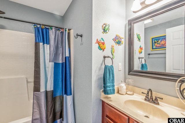 100 Amherst Dr Unit 3, Kill Devil Hills, NC 27948 - bathroom with vanity, shower / bathtub combination with curtain, and a textured wall
