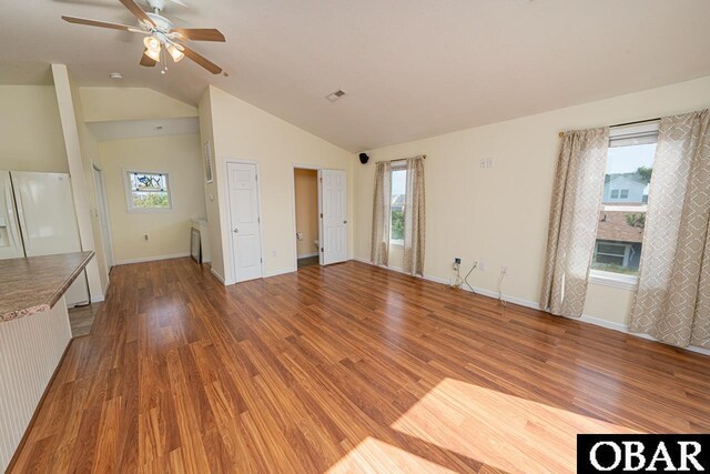 317 W Sandpiper Ter Lot 35, Nags Head, NC 27959 - unfurnished living room with vaulted ceiling, a healthy amount of sunlight, ceiling fan, and wood finished floors