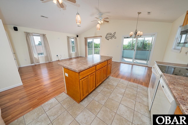 317 W Sandpiper Ter Lot 35, Nags Head, NC 27959 - kitchen with brown cabinets, ceiling fan with notable chandelier, a healthy amount of sunlight, open floor plan, and electric stove