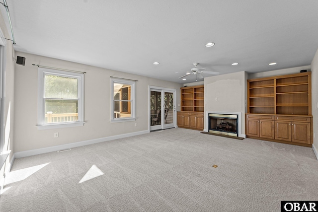 604 W First St Lot 321, Kill Devil Hills, NC 27948 - unfurnished living room with baseboards, recessed lighting, a fireplace with raised hearth, light carpet, and a ceiling fan