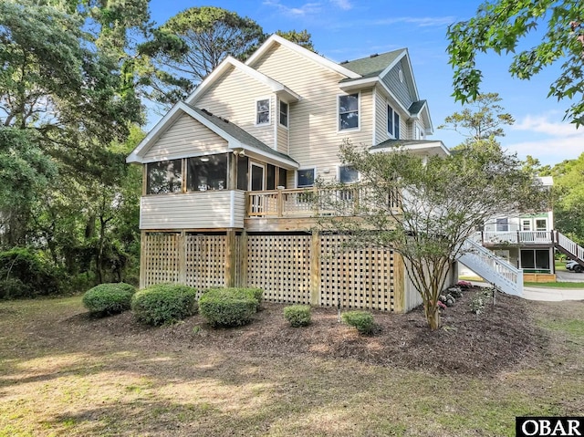604 W First St Lot 321, Kill Devil Hills, NC 27948 - back of property with a sunroom, stairs, a shingled roof, and a wooden deck