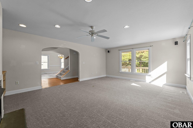 604 W First St Lot 321, Kill Devil Hills, NC 27948 - unfurnished living room with arched walkways, ceiling fan, carpet, stairway, and recessed lighting