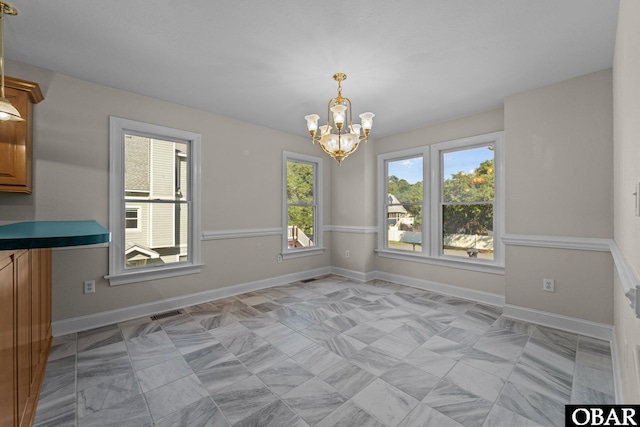604 W First St Lot 321, Kill Devil Hills, NC 27948 - unfurnished dining area featuring a chandelier and baseboards