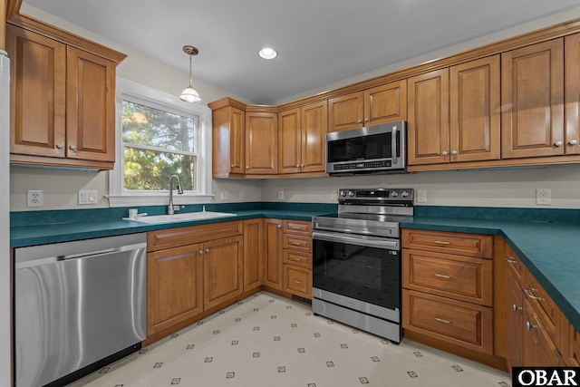 604 W First St Lot 321, Kill Devil Hills, NC 27948 - kitchen featuring stainless steel appliances, a sink, brown cabinetry, dark countertops, and recessed lighting