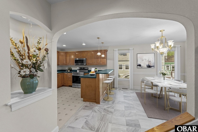 604 W First St Lot 321, Kill Devil Hills, NC 27948 - kitchen featuring appliances with stainless steel finishes, arched walkways, a chandelier, dark countertops, and recessed lighting