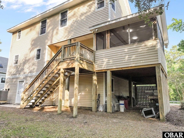 604 W First St Lot 321, Kill Devil Hills, NC 27948 - back of property featuring a sunroom, stairs, a wooden deck, and central air condition unit