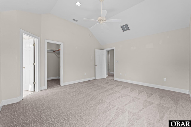 604 W First St Lot 321, Kill Devil Hills, NC 27948 - unfurnished bedroom featuring vaulted ceiling, light colored carpet, a walk in closet, a ceiling fan, and baseboards