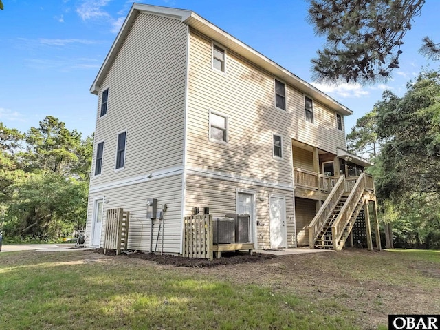 604 W First St Lot 321, Kill Devil Hills, NC 27948 - back of property featuring a wooden deck, stairway, and a yard