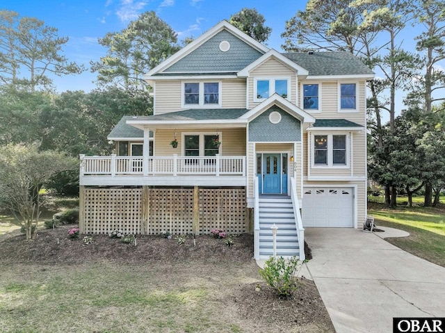 604 W First St Lot 321, Kill Devil Hills, NC 27948 - view of front of house with driveway, an attached garage, a porch, stairs, and a shingled roof