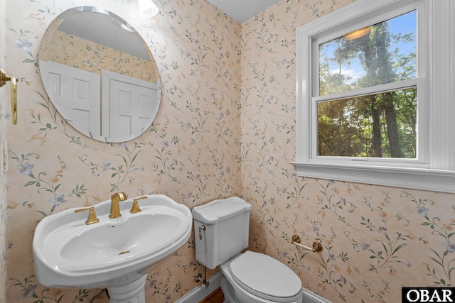 604 W First St Lot 321, Kill Devil Hills, NC 27948 - bathroom with wallpapered walls, toilet, a sink, and baseboards