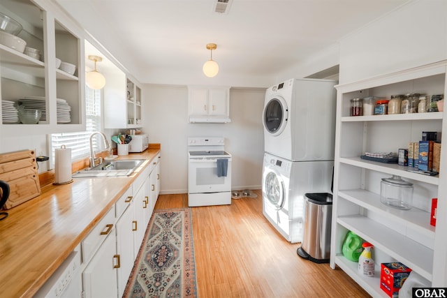 24217 N Holiday Blvd Lot 79, Rodanthe, NC 27968 - kitchen with white appliances, estacked washer and dryer, under cabinet range hood, white cabinets, and light wood-style floors