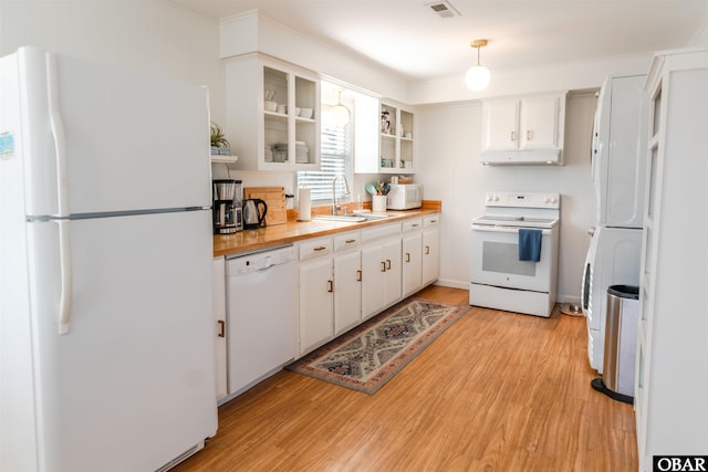 24217 N Holiday Blvd Lot 79, Rodanthe, NC 27968 - kitchen featuring white appliances, under cabinet range hood, light wood-style flooring, white cabinetry, and glass insert cabinets