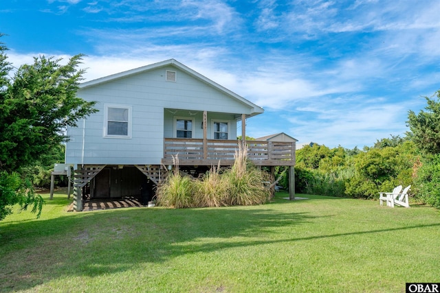 24217 N Holiday Blvd Lot 79, Rodanthe, NC 27968 - back of property with a lawn and a wooden deck