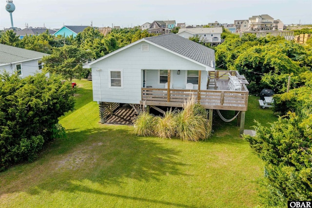 24217 N Holiday Blvd Lot 79, Rodanthe, NC 27968 - rear view of house with a yard and a wooden deck