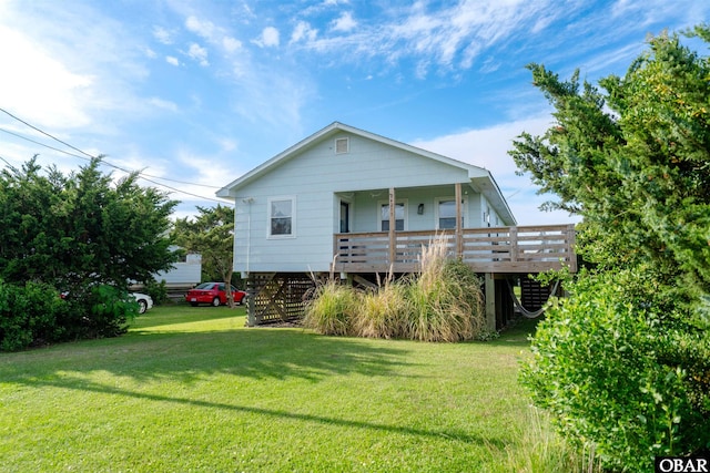24217 N Holiday Blvd Lot 79, Rodanthe, NC 27968 - back of property featuring a lawn and a porch