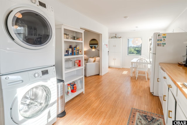 24217 N Holiday Blvd Lot 79, Rodanthe, NC 27968 - laundry area featuring estacked washer and dryer and light wood finished floors